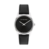 Calvin Klein Women’s Dressed Watch, 32mm stainless steel case, black sunray dial, crystal-set bezel, silver-tone hands, minimalist design, black leather strap, Swiss-made quartz movement.