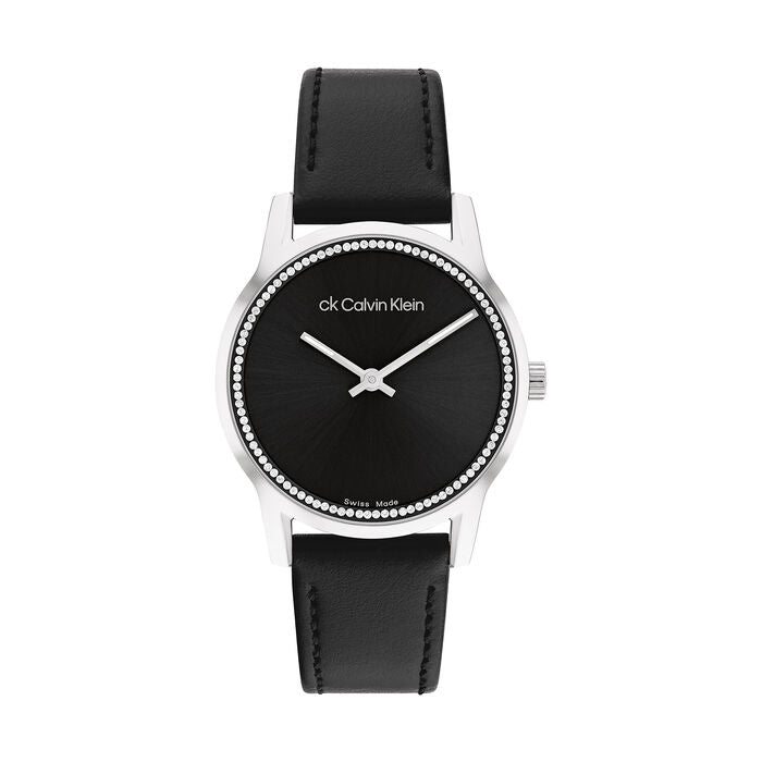 Calvin Klein Women’s Dressed Watch, 32mm stainless steel case, black sunray dial, crystal-set bezel, silver-tone hands, minimalist design, black leather strap, Swiss-made quartz movement.