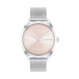 Calvin Klein Women’s Enticing Watch, 36mm stainless steel case, blush pink sunray dial with silver-tone hands and minimalist hour markers, silver mesh bracelet, elegant and modern quartz timepiece.