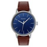 Hugo Boss Stand men's watch, 42mm silver-tone stainless steel case, blue sunray dial with minimalist hour markers and "TEN" text at 10 o'clock, brown textured leather strap, bold and modern design.